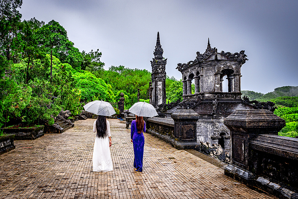 Women with umbrellas walking at Khai Dinh Mausoleum, Hue, Central Vietnam. (MR)
