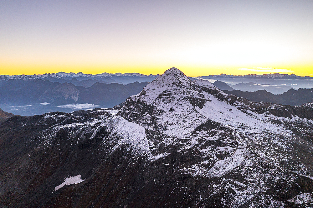 Pizzo Scalino peak covered with snow at dawn in autumn, aerial view, Valmalenco, Sondrio province, Valtellina, Lombardy, Italy