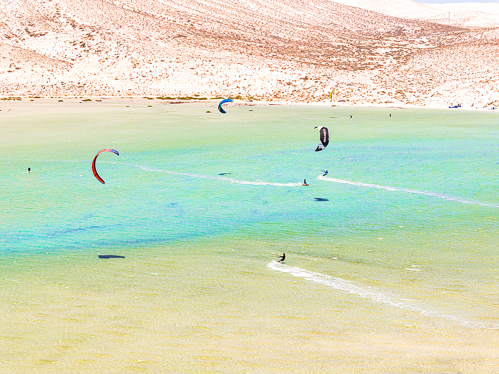 Aerial view of kitesurfers surrounded by volcanic cliffs, Sotavento beach, Jandia, Fuerteventura, Canary Islands, Spain