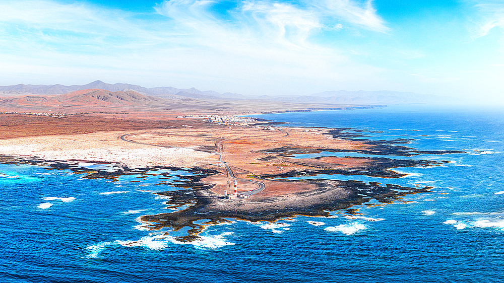 Aerial view of El Toston Lighthouse on volcanic coastline, El Cotillo, Fuerteventura, Canary Islands, Spain