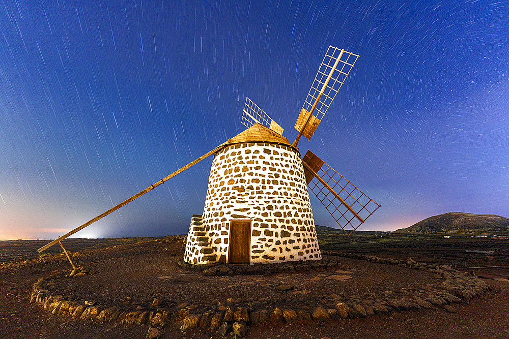 Starry night sky over a traditional stone mill, Fuerteventura, Canary Islands, Spain