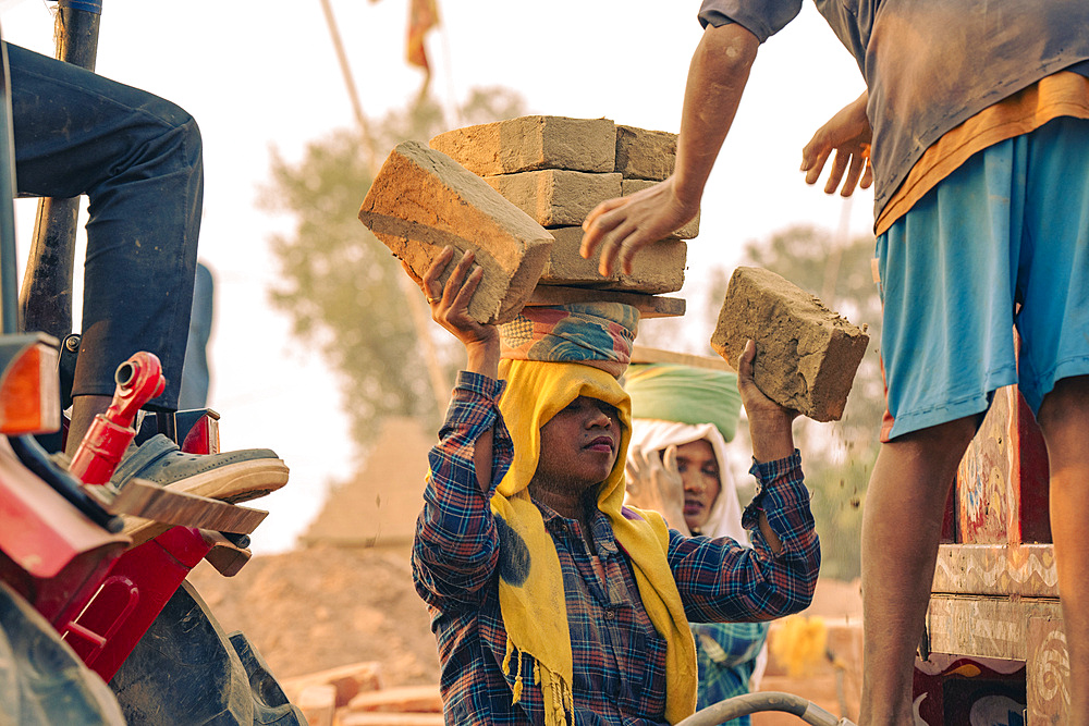 Women labourers working in a brick factory in Assam, India