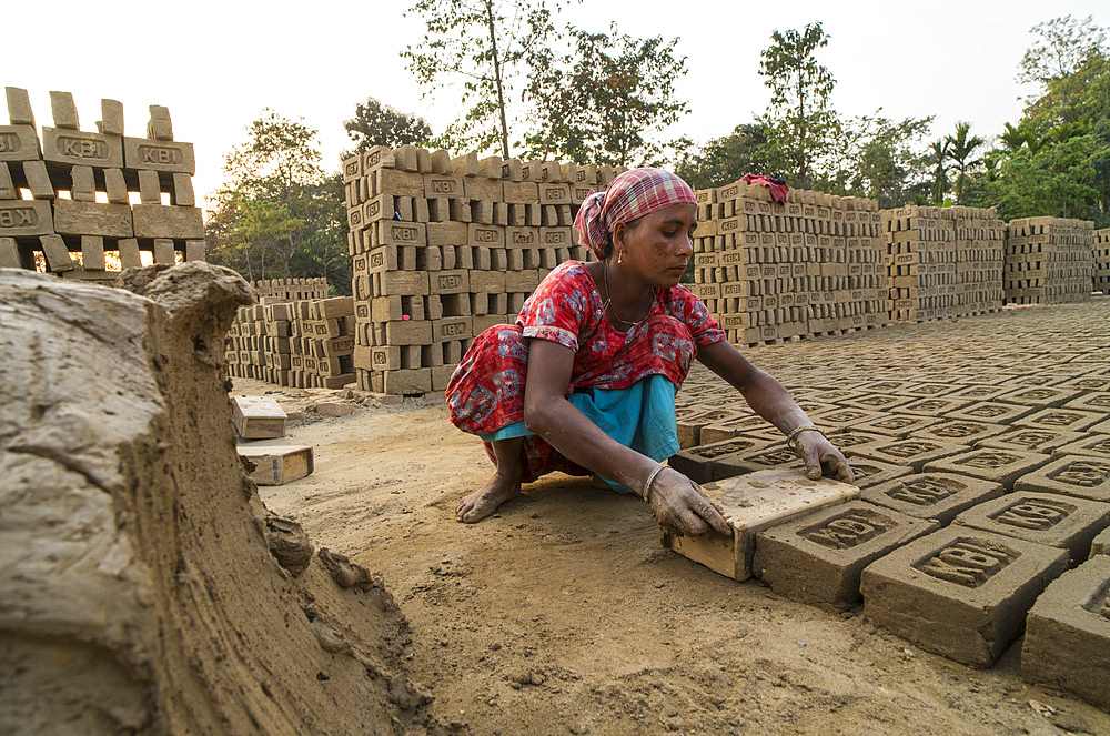Women labourers working in a brick factory in Assam, India
