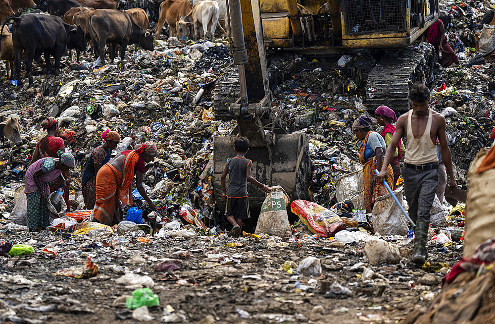 Ragpickers collect reusable items at a garbage dumping site on May 27, 2025 in Guwahati, India.