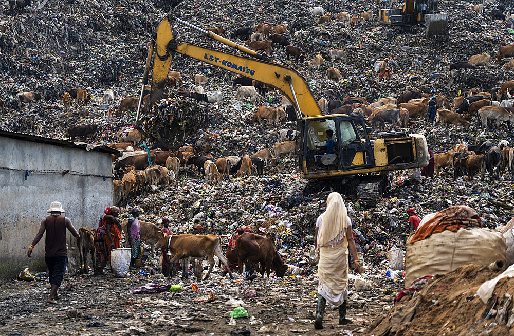 Municipality excavator working at a garbage dumping site on May 27, 2025 in Guwahati, India.