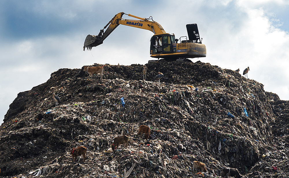 Municipality excavator working at a garbage dumping site on May 27, 2025 in Guwahati, India.