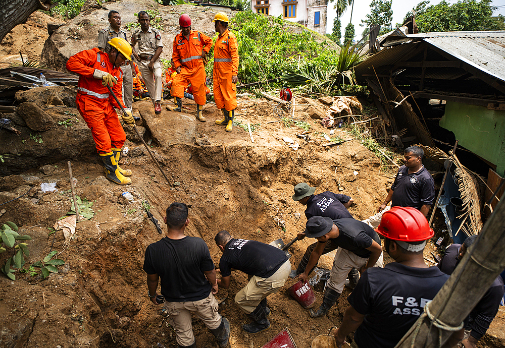 National Disaster Response Force (NDRF) personnel busy in rescue operations after a major landslide, triggered by a heavy downpour, on June 7, 2025 in Guwahati, India.