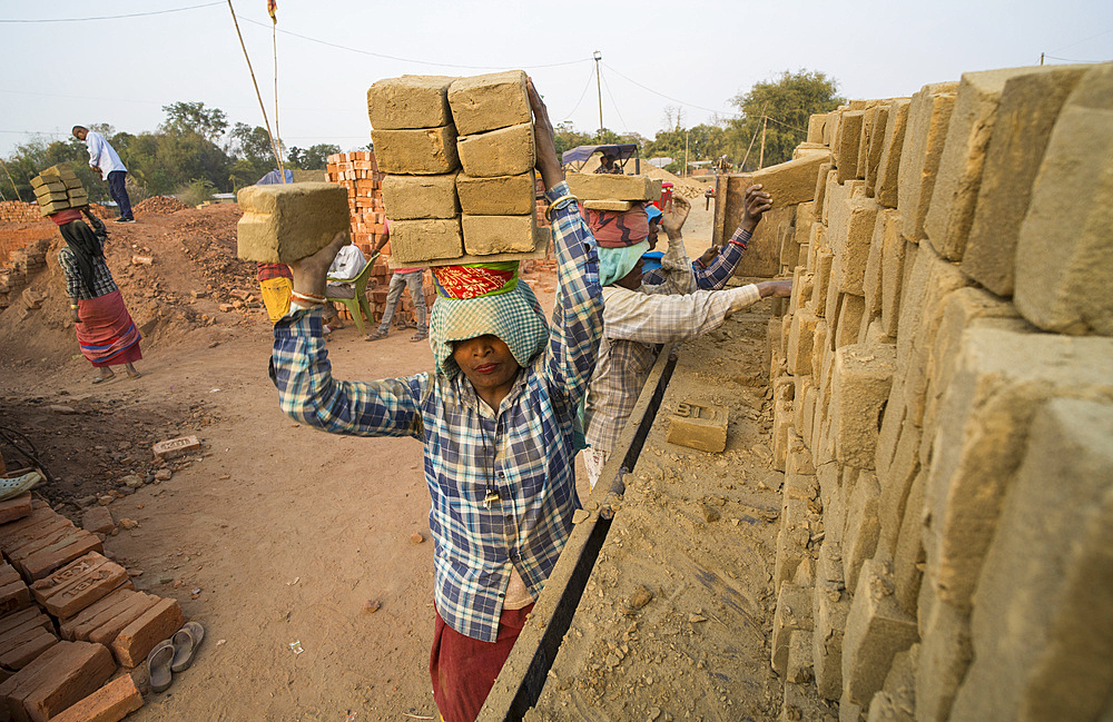 Women labourers working in a brick factory in Assam, India