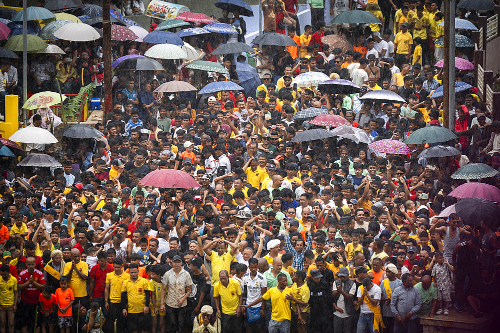 People attend an event holding umbrellas to mark the Behdienkhlam festival in Jowai, India, on July 14, 2025.