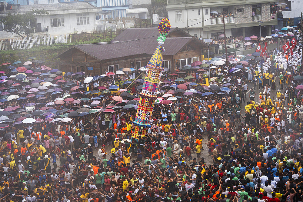 People from the Pnar community march in a circle around a Rot as they celebrate an event organised to mark the Behdienkhlam festival in Jowai, India, on July 14, 2025.