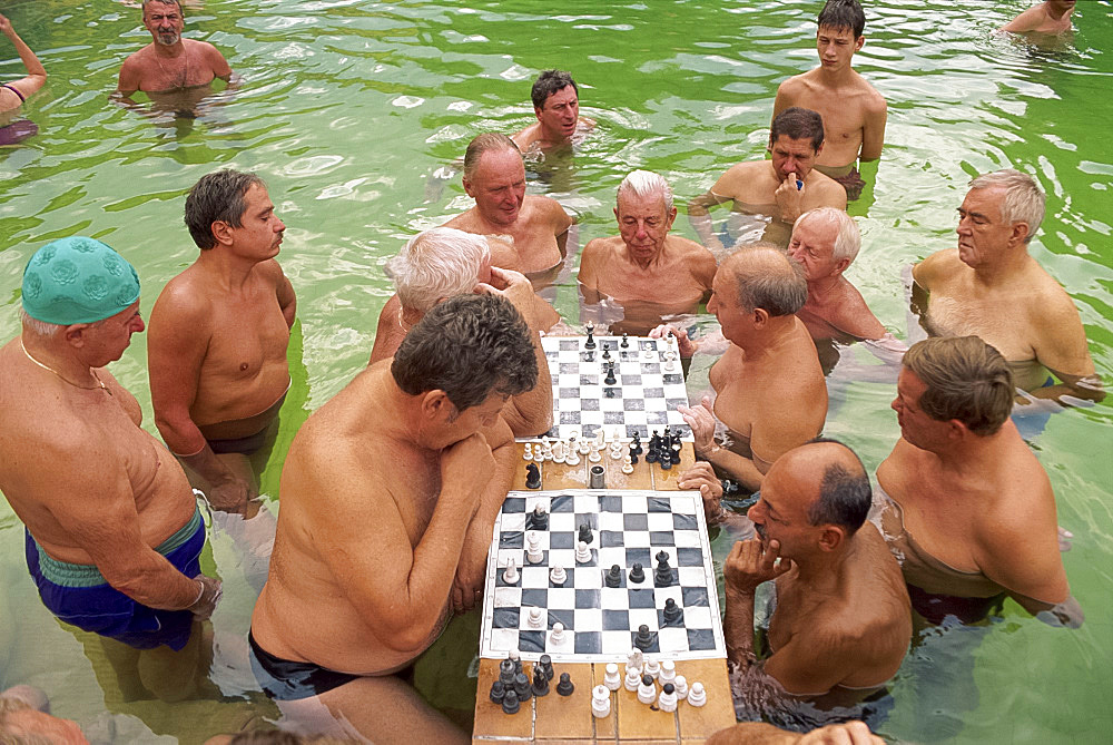 Bathers playing chess in the water at the Szechenyi Baths in Budapest, Hungary, Europe