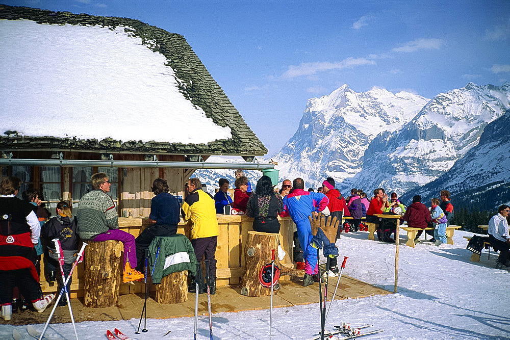 People take a break from skiing in mountain top bar, Wengen, Bernese Oberland, Switzerland, Europe