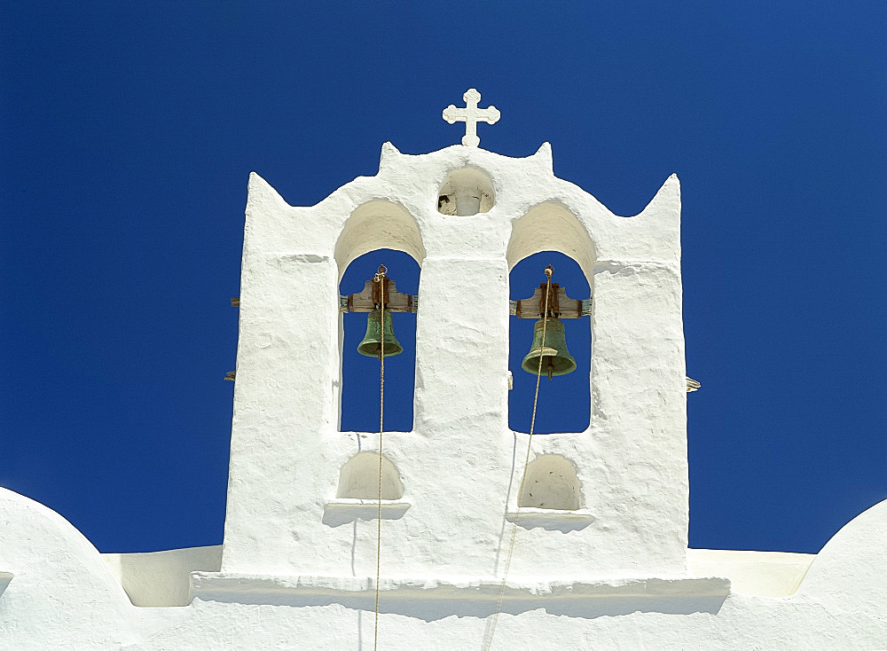 Close-up of the white walls and bells in the bell tower of the Church of Agio Constantino in Artemonas, on Sifnos, Cyclades, Greek Islands, Greece, Europe