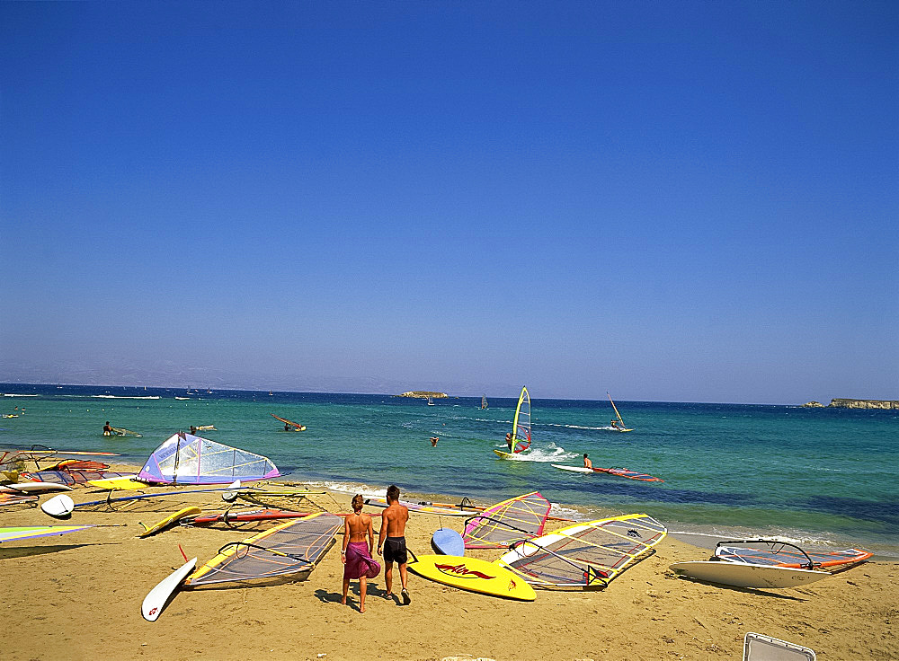 Couple going windsurfing at Golden Beach on Paros, Cyclades, Greek Islands, Greece, Europe