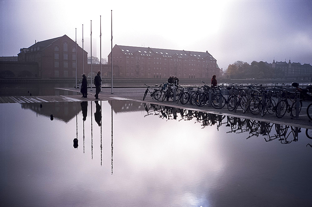 Bicycles reflected in still water, Christians Brygge, Copenhagen, Denmark, Scandinavia, Europe