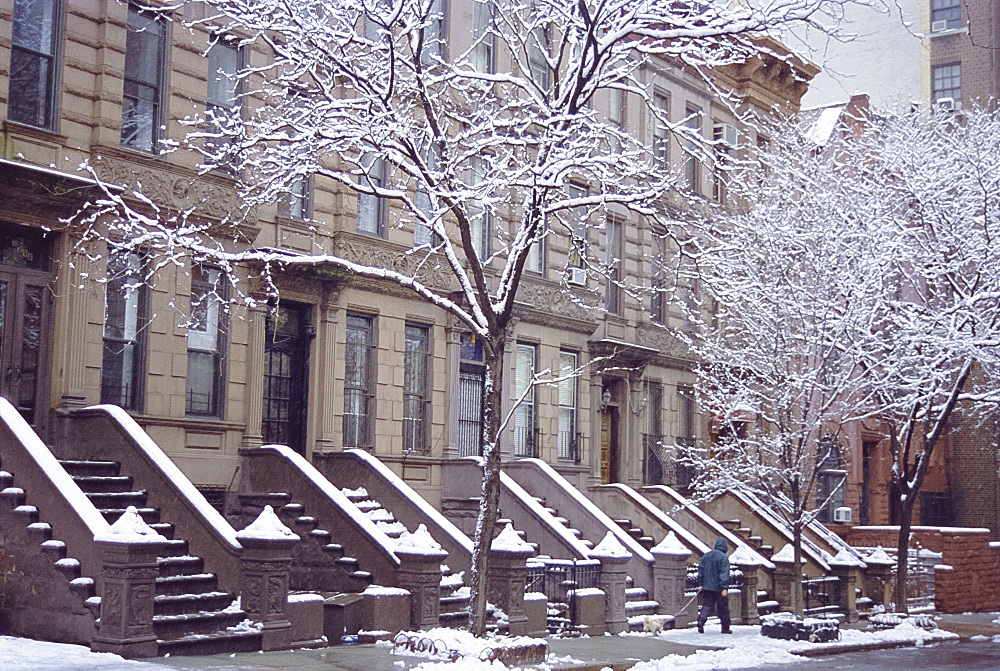 Old brownstone style houses after a snowstorm, New York City, New York, USA