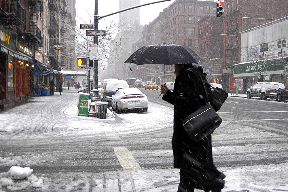 New Yorkers on city street during a snowstorm, New York City, USA, North America