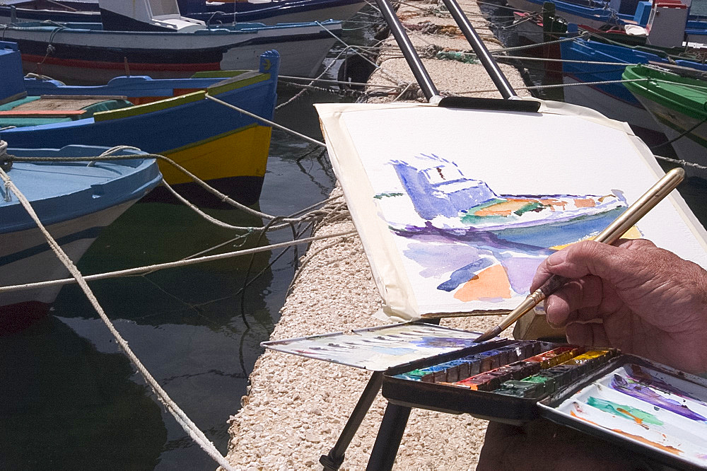 Close-up of artist painting boats in a harbour, Italy, Mediterranean, Europe