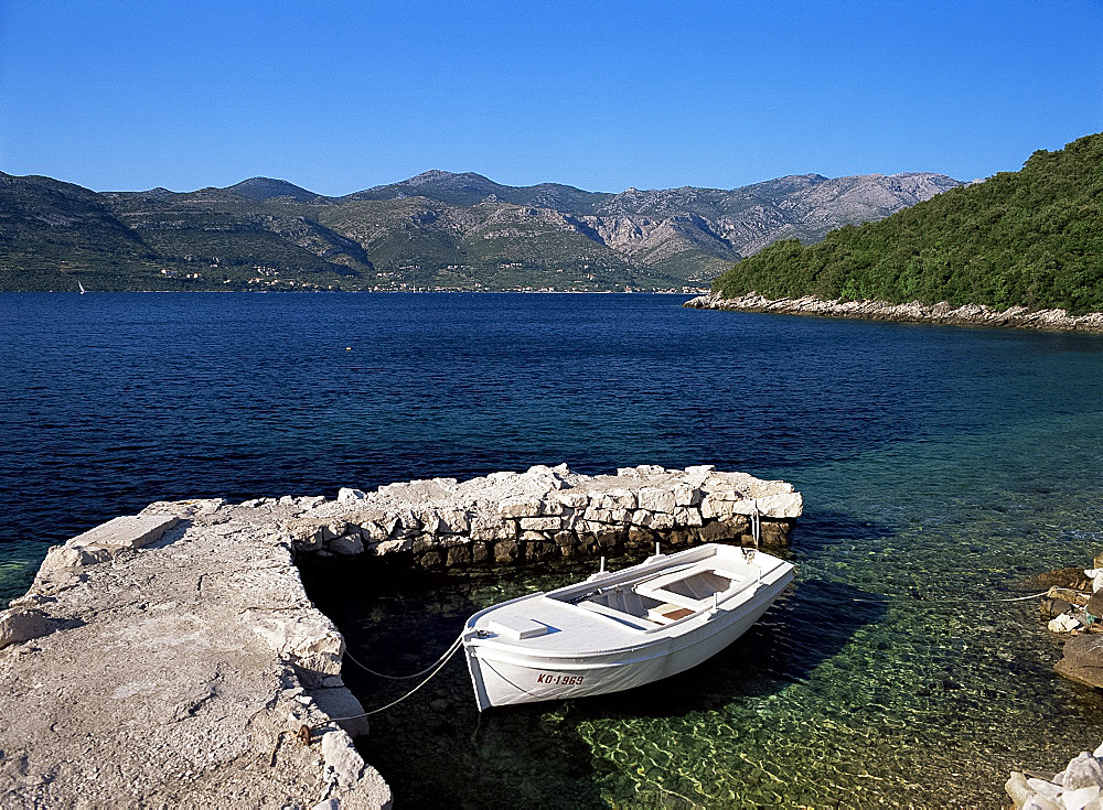 A small boat in clear seas off the island of Korcula, Dalmatia, Croatia, Europe