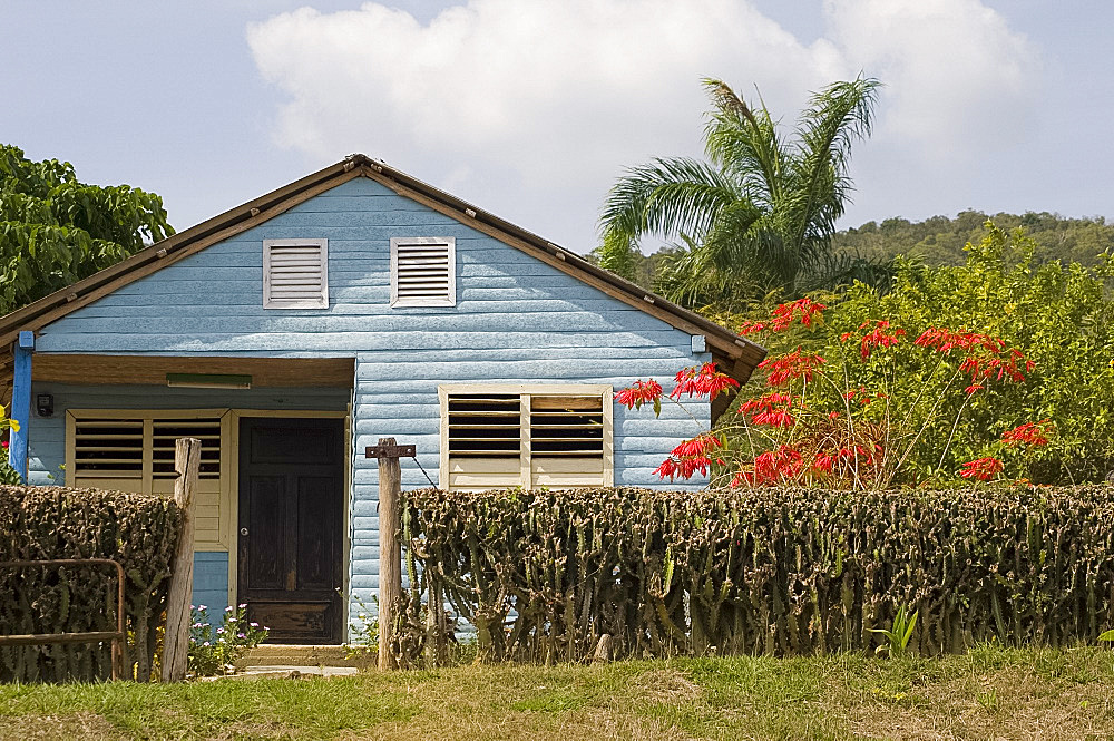 A small wooden house with traditional shutters on the windows in the countryside, Holguin, Cuba, West Indies, Central America