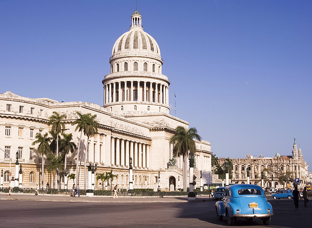 A vintage American car parked in front of the Capitolio building in central Havana, Cuba, West Indies, Central America