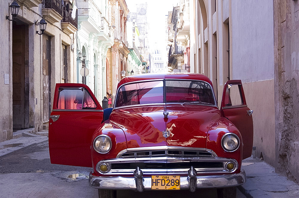 An old car in a small street in Habana Vieja (old town), Havana, Cuba, West Indies, Central America