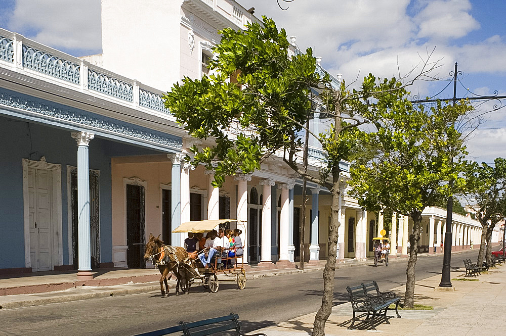 A horse and carriage going past row of columns in the Paseo del Prado, the main avenue, Cienfuegos, Cuba, West Indies, Central America