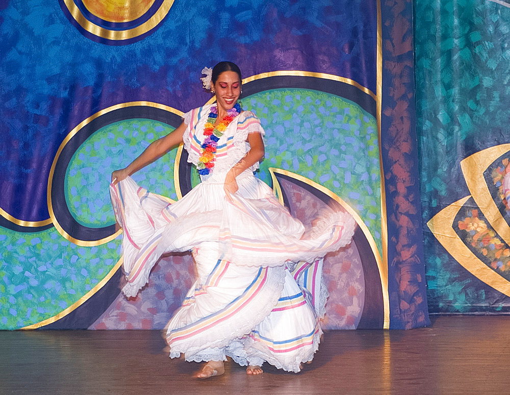 A flamenco dancer in colourful costume performing during the evening entertainment at the Melia Rio de Oro Hotel, Playa Esmeralda, Guardalavaca, Cuba, West Indies, Central America