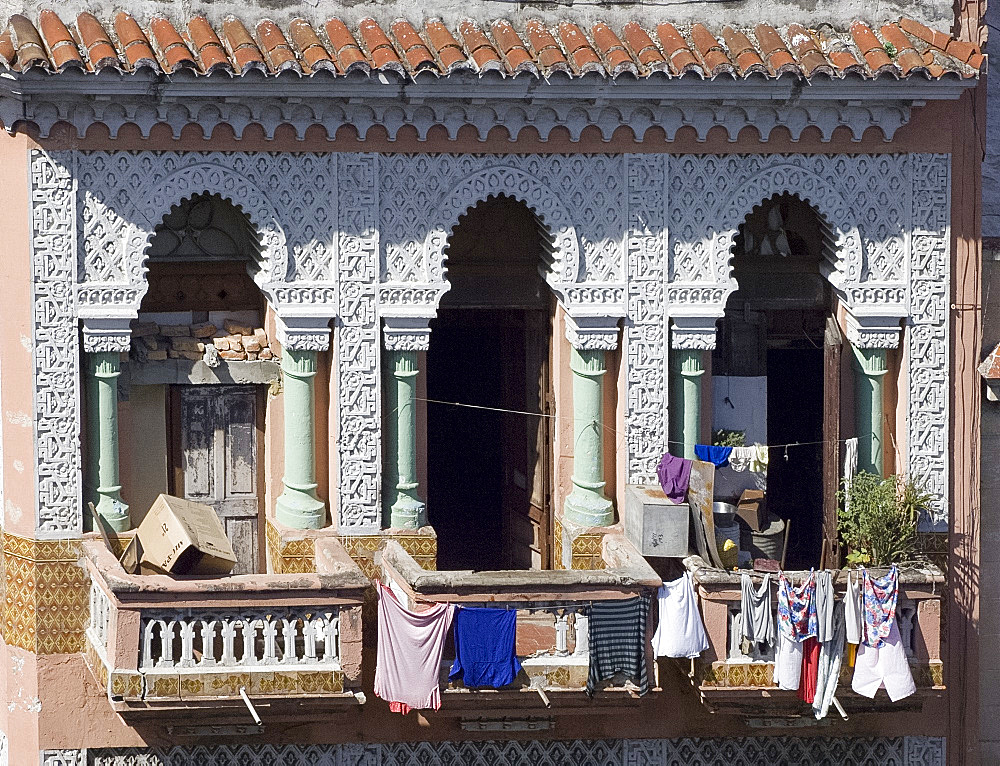 Laundry hanging from the balcony of an ornate Moorish style building in central Havana, Cuba, West Indies, Central America