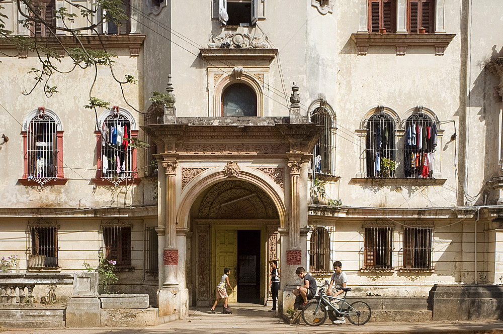 Children playing in front of an ornate old building in the Vedado section, Havana, Cuba, West Indies, Central America