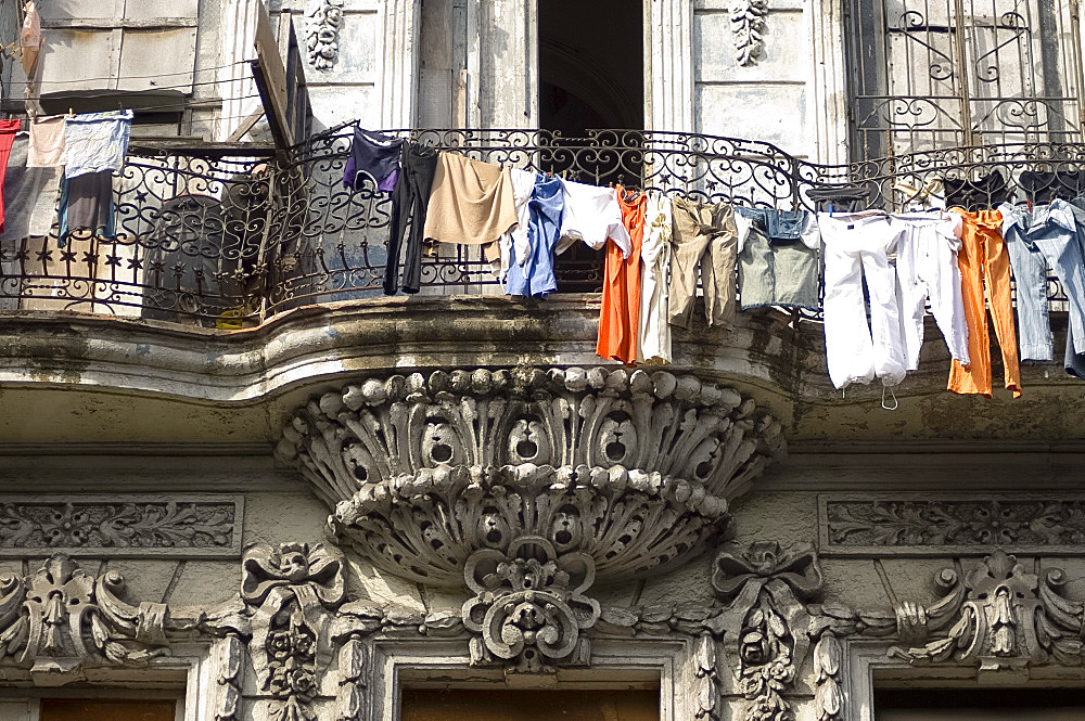 Laundry hanging in front of an ornate old building on the Paseo del Prado, Havana, Cuba, West Indies, Central America