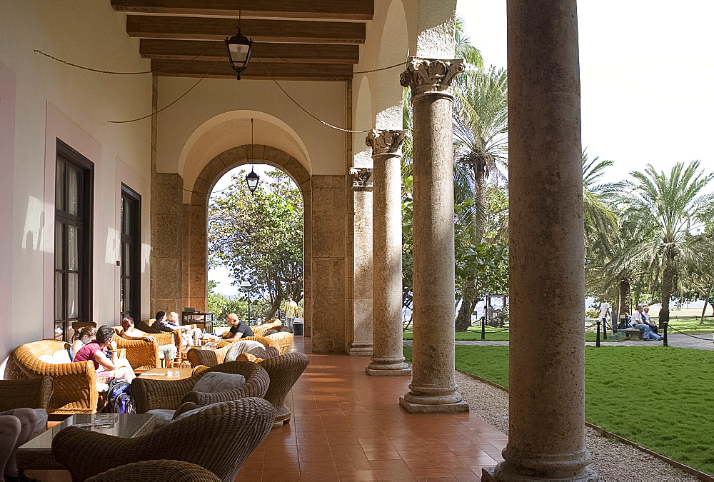 Guests relaxing on a veranda outside the Nacional Hotel, Havana, Cuba, West Indies, Central America