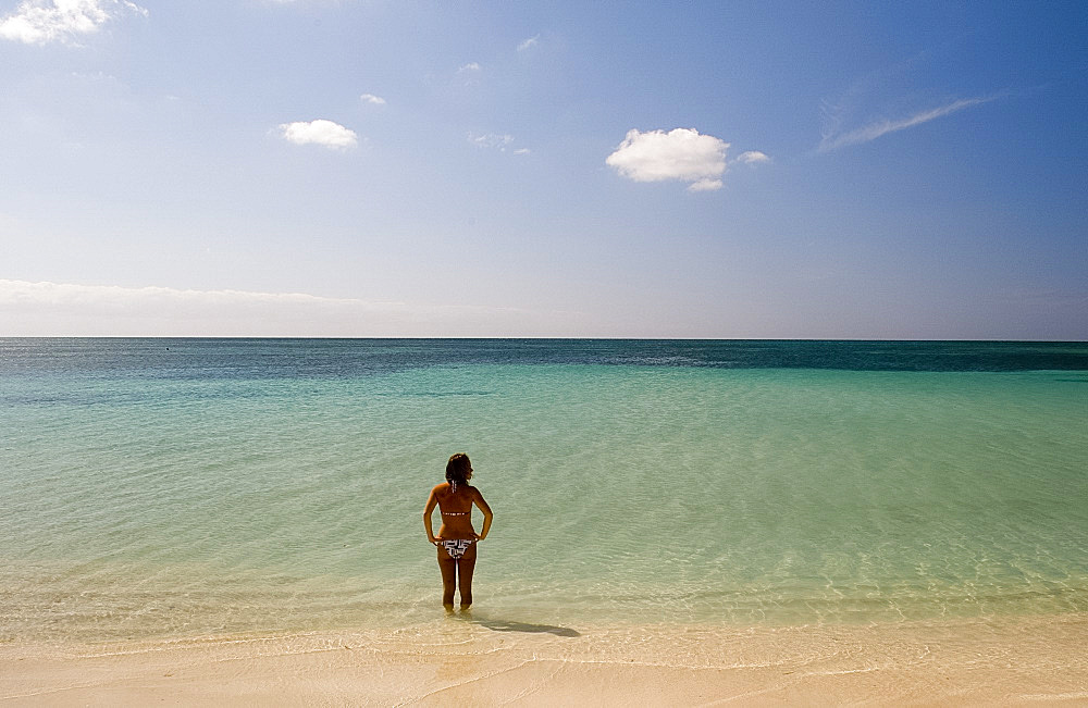 A lone woman in a bikini in the sea at Playa Ancon, Trinidad, Cuba, West Indies, Central America