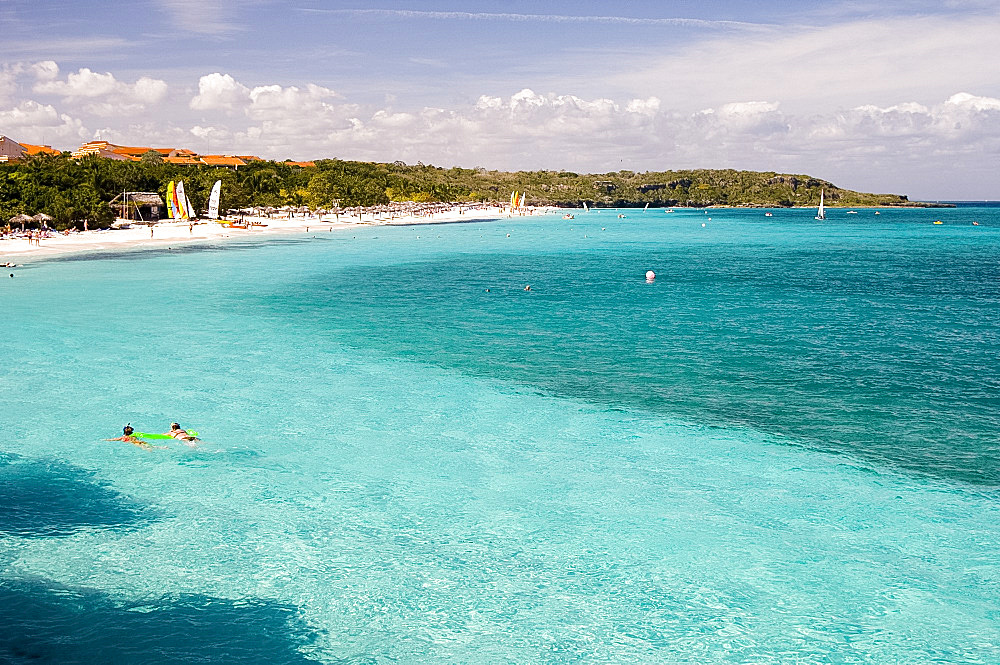 Swimmers in aqua seas, Playa Esmeralda, Carretera Guardalavarca, Cuba, West Indies, Central America