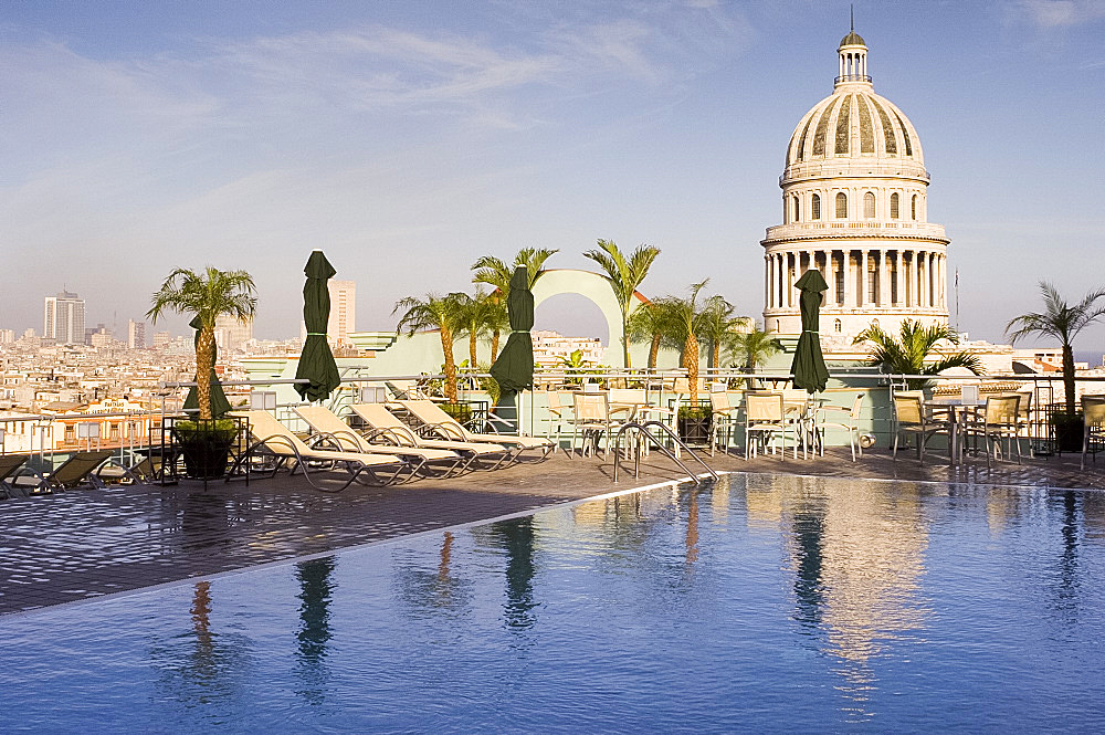 A swimming pool on the roof terrace of the Hotel Saratoga overlooking the Capitolio in central Havana, Cuba, West Indies, Central America