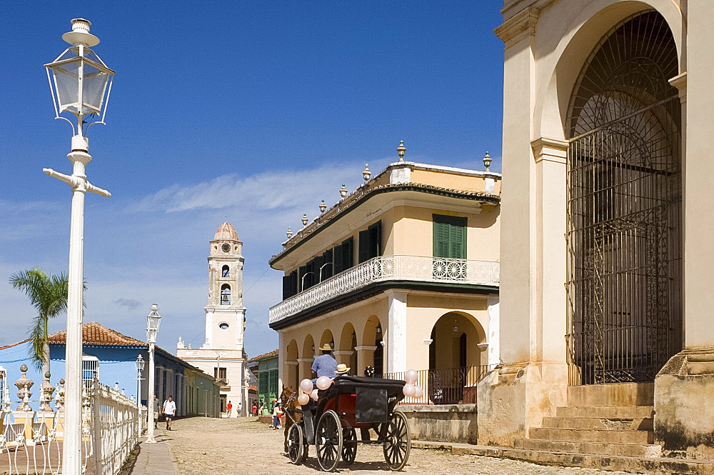 A horse and carriage on the cobbled streets near the Iglesia y Convento de San Francisco and Palacio Brunet, Trinidad, UNESCO World Heritage Site, Cuba, West Indies, Central America