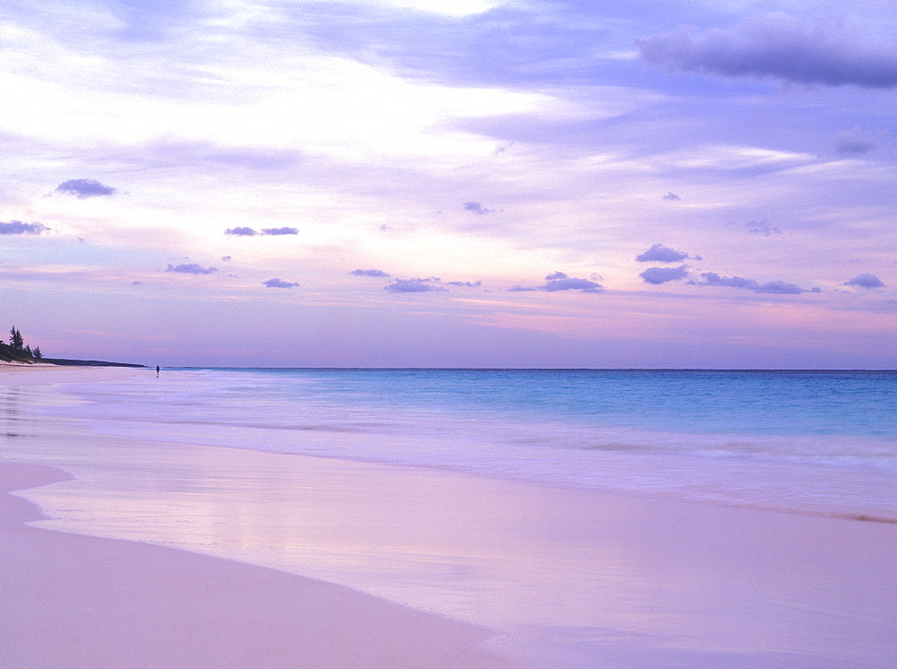 Pink Sands Beach at dusk with a person in the distance, Harbour Island, Eleuthera, The Bahamas, West Indies, Atlantic, Central America