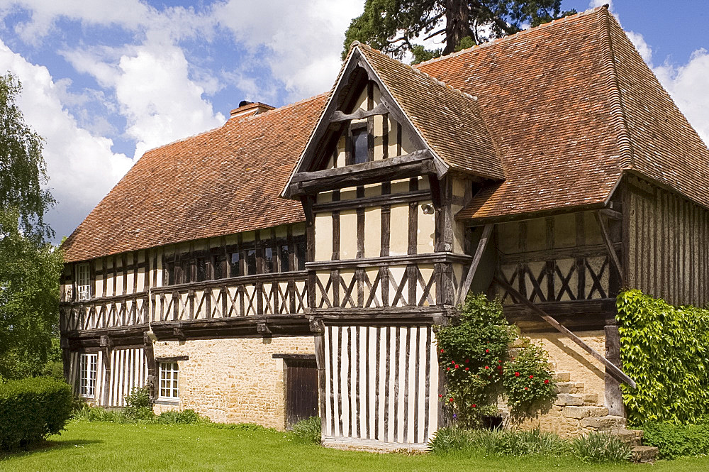 A half timbered barn with rose covered stone steps in Mezidon-Canon, Normandy, France, Europe