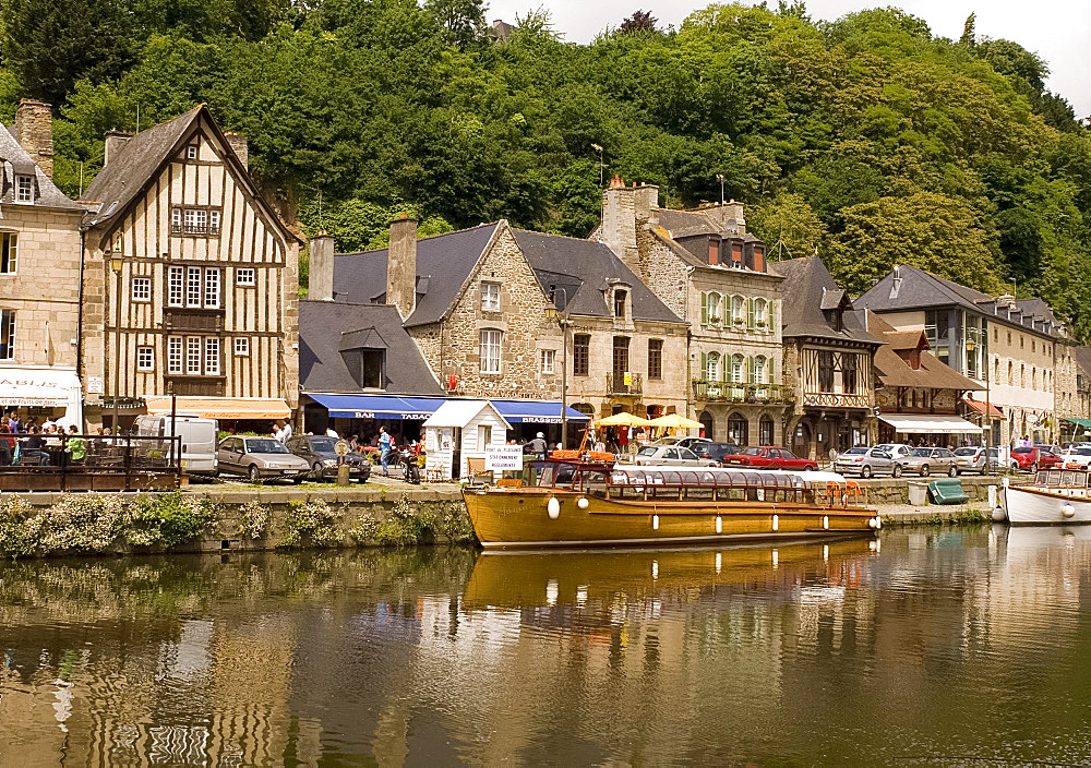 Boats on the River Rance, medieval buildings, and waterfront cafes in Port du Dinan, Brittany, France, Europe