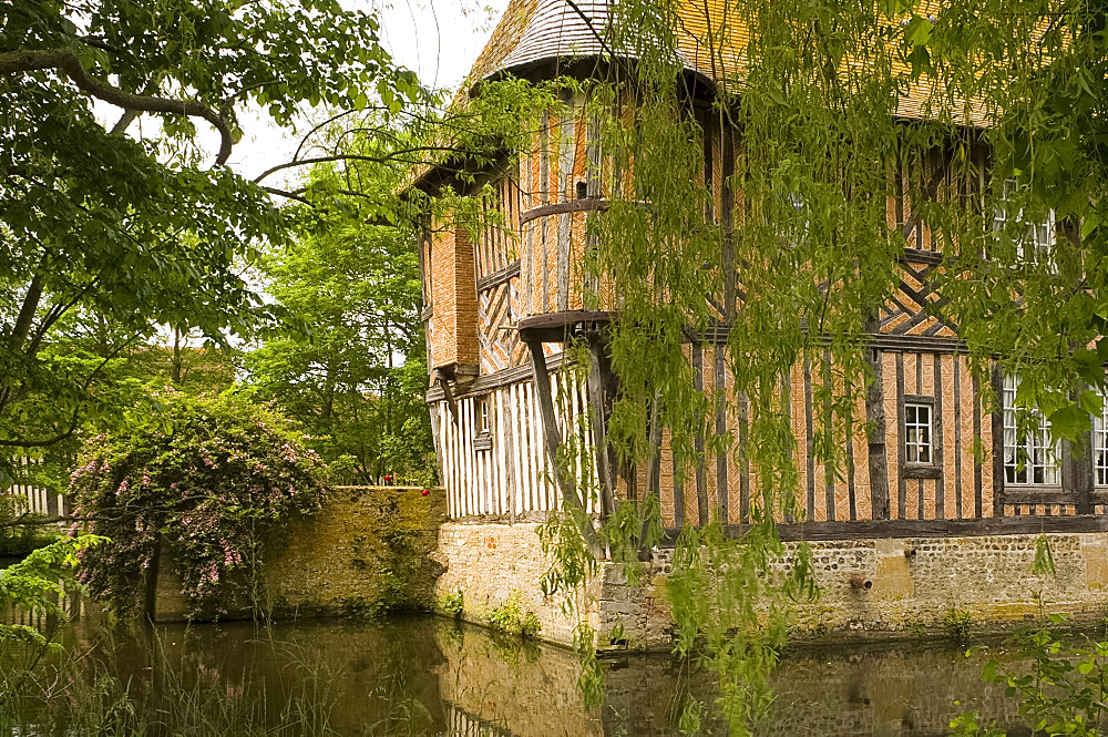 The half timbered manoire (manor house) and surrounding moat in Coupesarte, Normandy, France, Europe