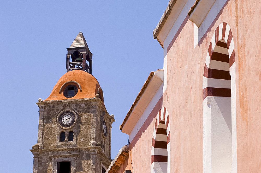 A mosque next to a church belltower in Rhodes Town, Rhodes, Dodecanese, Greek Islands, Greece, Europe