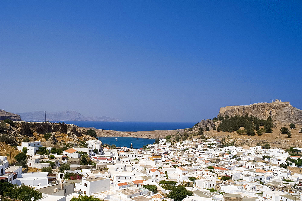 Aerial view of Lindos, Lindos Bay and the Acropolis, Rhodes, Dodecanese Islands, Greek Islands, Greece, Europe