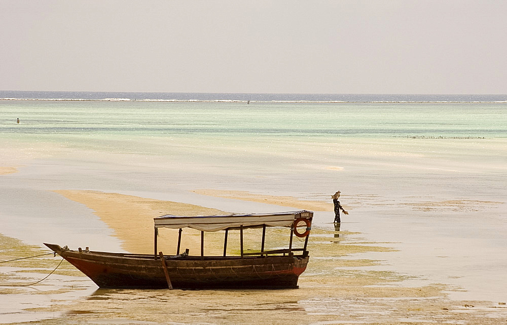 An old wooden boat in the sea at low tide, Paje, Zanzibar, Tanzania, East Africa, Africa