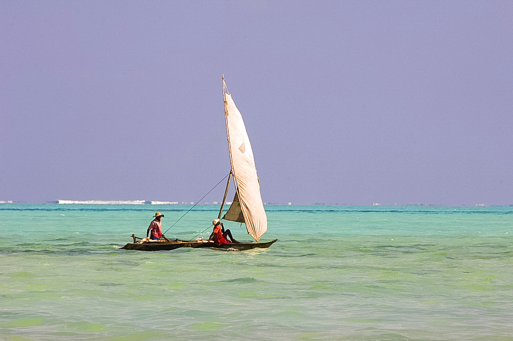 Two men on a traditional wooden dhow with sail, Zanzibar, Tanzania, East Africa, Africa