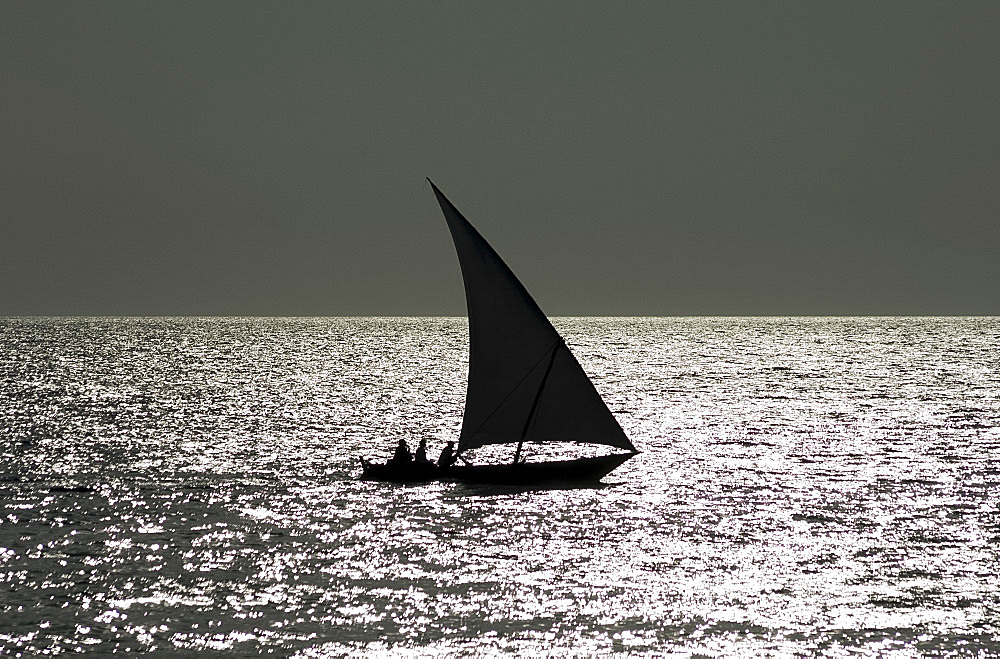 A dhow in silhouette near Stone Town, Zanzibar, Tanzania, East Africa, Africa