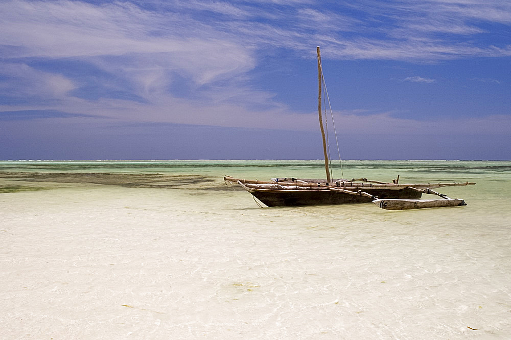 A dhow on Kiwendwa Beach at low tide, Zanzibar, Tanzania, East Africa, Africa