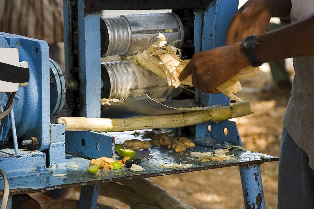 A man pressing sugar cane for juice, Stone Town, Zanzibar, Tanzania, East Africa, Africa