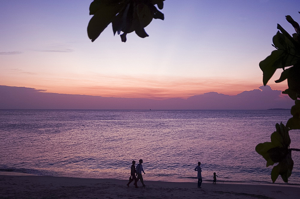 People walking on the beach at sunset, Stone Town, Zanzibar, Tanzania, East Africa, Africa