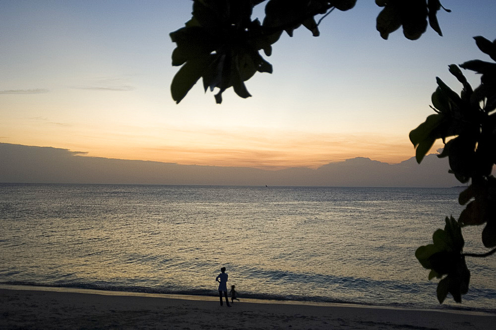 People walking on the beach at sunset, Stone Town, Zanzibar, Tanzania, East Africa, Africa