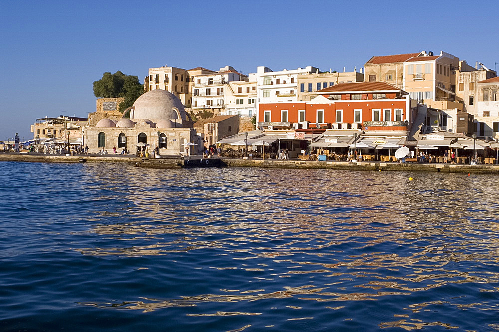 A view of tavernas around the harbour and the Kutchuk Hasan Mosque in the old town section of Hania (Chania) (Xania), Crete, Greece, Europe